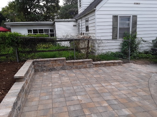 Backyard stone paver patio and garden wall finished